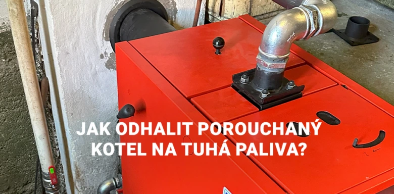 Červený kotel na tuhá paliva s potrubím v interiéru