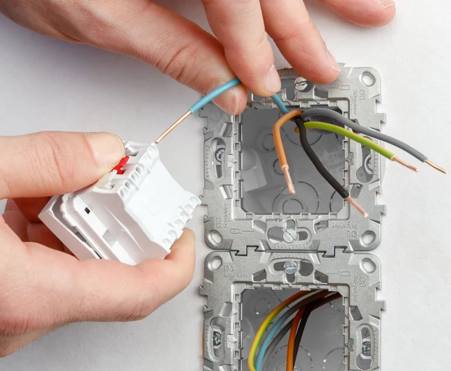 Ruční instalace elektrického spínače s připojením vodičů.