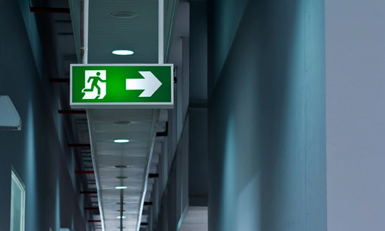 Emergency exit sign in hallway