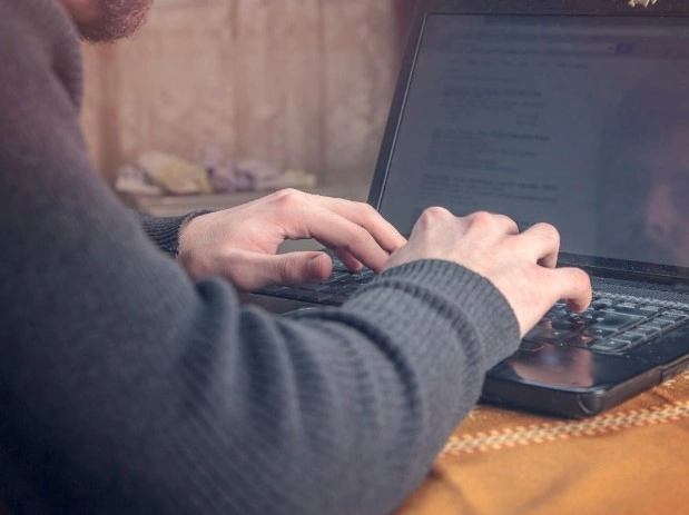 Person typing on laptop