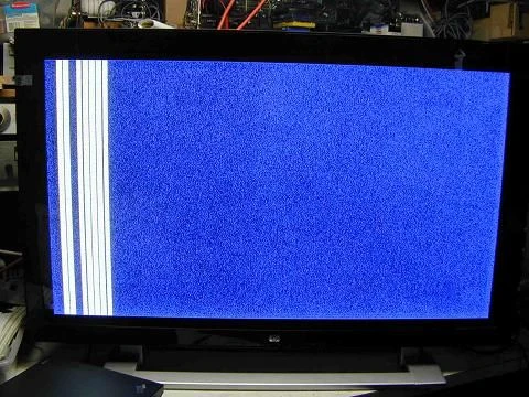 Televize s modrým pozadím a barevnými pruhy na obrazovce.