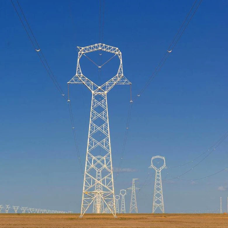 Electricity pylons in field