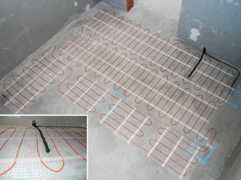 Instalace elektrického podlahového topení s kabely na mřížce před pokládkou dlažby.