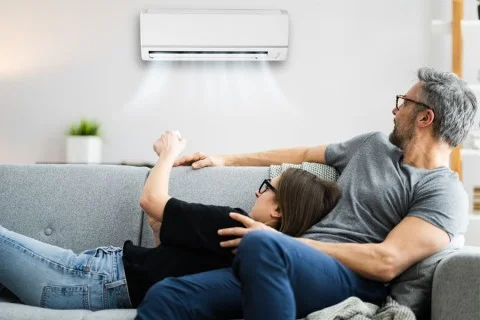 Couple relaxing with ac unit