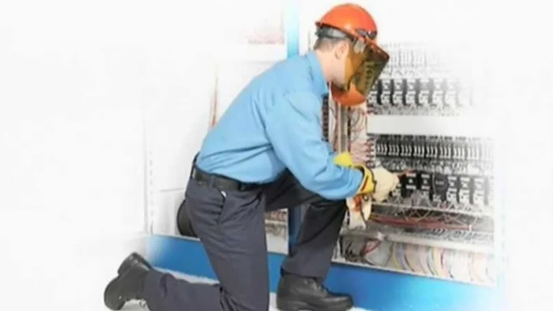 Electrician working on panel
