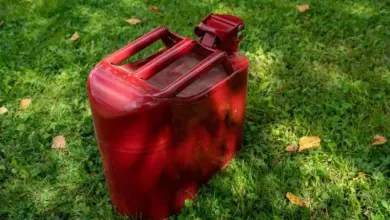 Red plastic fuel canister on grass