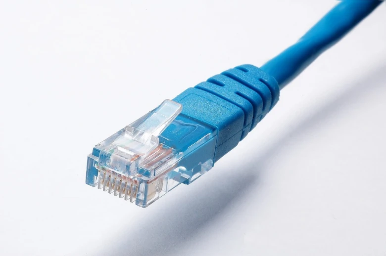 Modrý síťový kabel LAN s konektorem pro připojení počítačů.