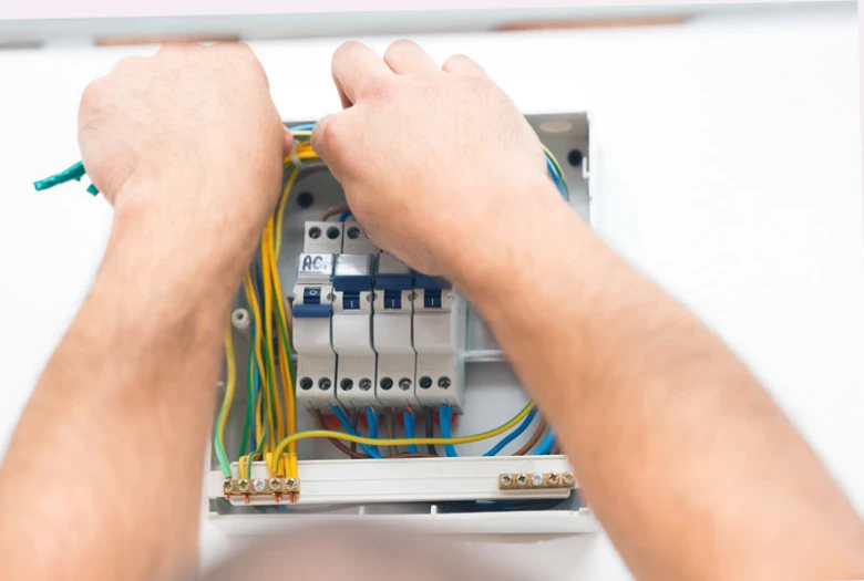 Ruční instalace elektrického rozvodu s vodiči a jističem v dřevěném domě